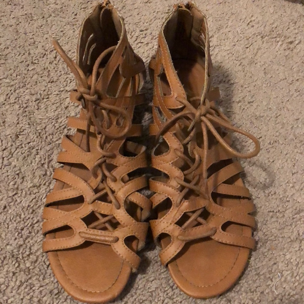 Brown lace up sandals.